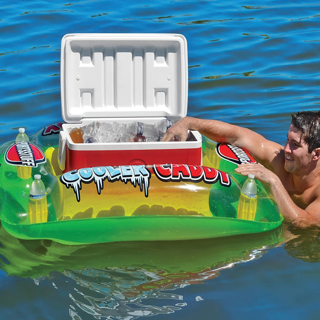 Man on a inflatable cooler float with a cooler full of drinks in the water