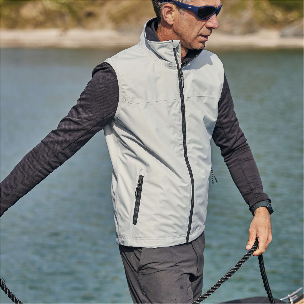 Person wearing Grey vest.