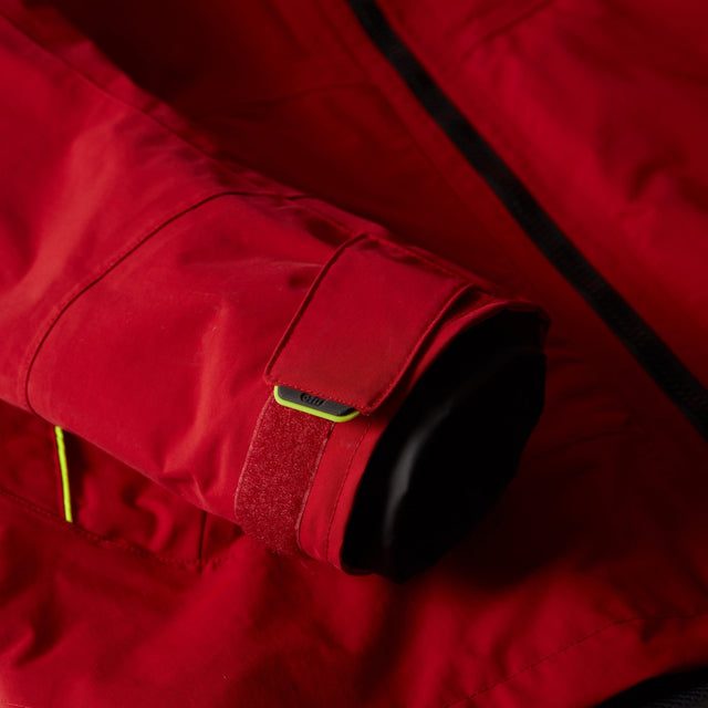 Close-up of a red jacket with black cuffs and yellow accents.