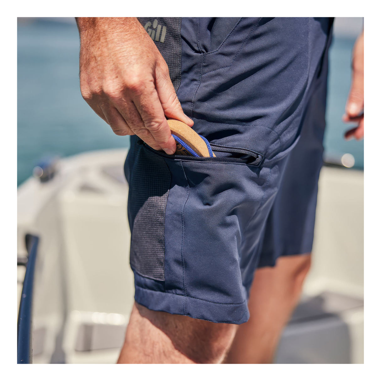 Person wearing Gill UV Stretch Pro Shorts - Men's, navy