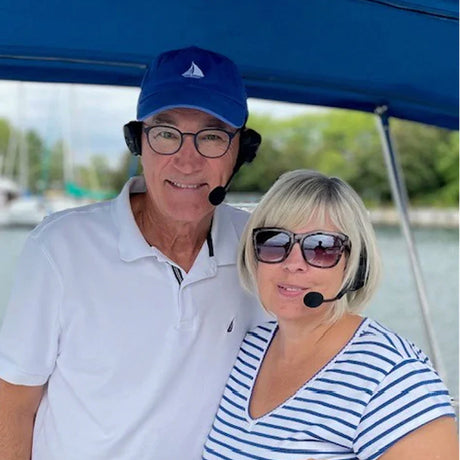 Couple wearing bluetooth headsets.