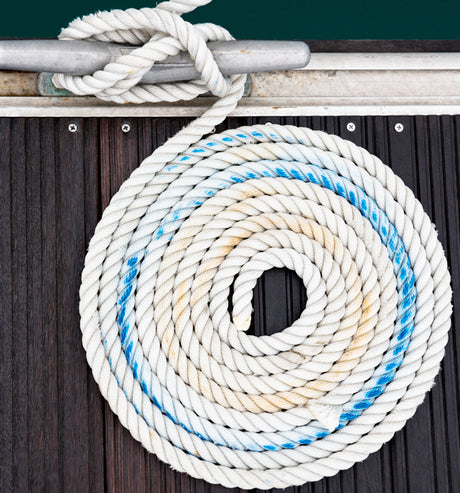 Line coiled on wooden deck.