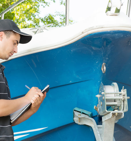 Person with checklist looking at trailer.