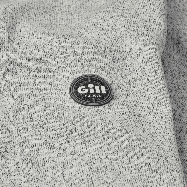 Gill logo on a textured gray fabric background