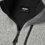 Close-up of a gray and black jacket with a Gill logo on a textured surface