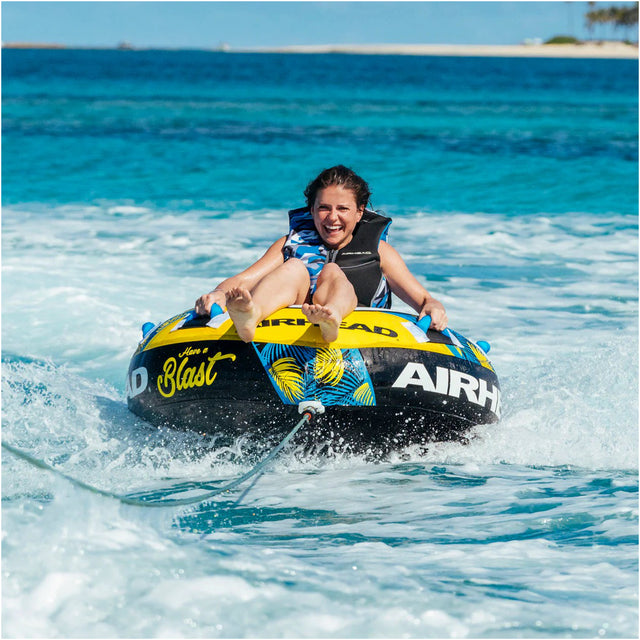 Person riding an Airhead tube in the ocean