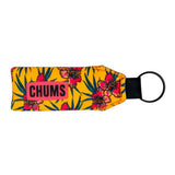 Floral-patterned keychain with 'CHUMS' branding on a yellow background