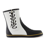 Black and white rain boot with yellow trim on a white background