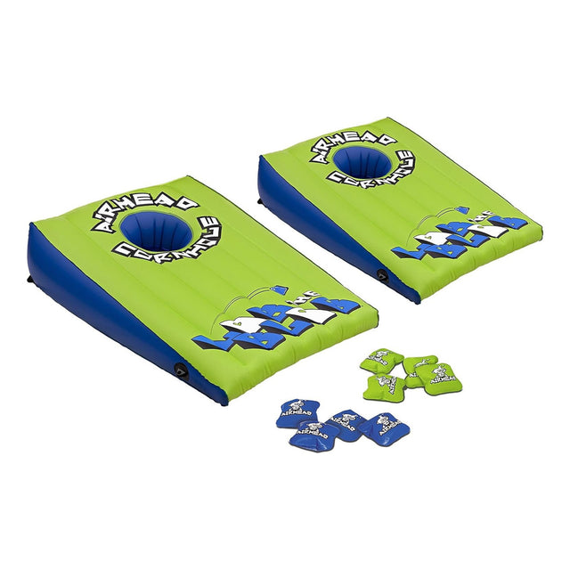 Two green and blue cornhole boards with bags on a white background