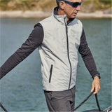Person wearing Grey vest.