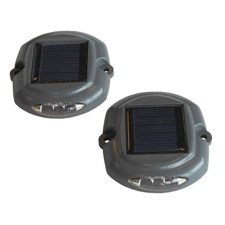 Two solar-powered outdoor lights on a white background