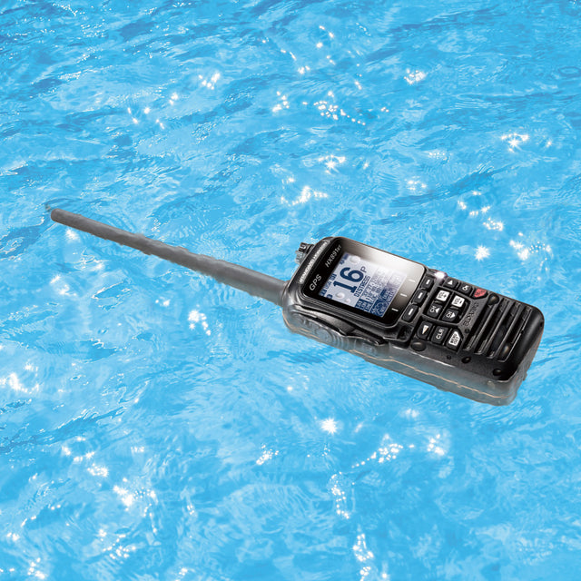 Black walkie-talkie floating on blue water