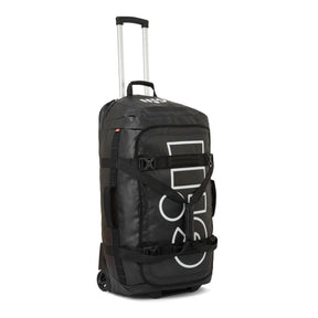 A black rolling duffel bag with an extended silver telescoping handle, featuring a large white vertical 'GOLI' logo on the front, black compression straps, and a top carry handle, set against a plain white background.