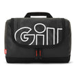 A black quilted GILL travel bag with a large white outlined 'GILL' logo on the front flap, featuring a top carry handle and a small red GILL tag on the left side.