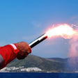 Person holding flare.